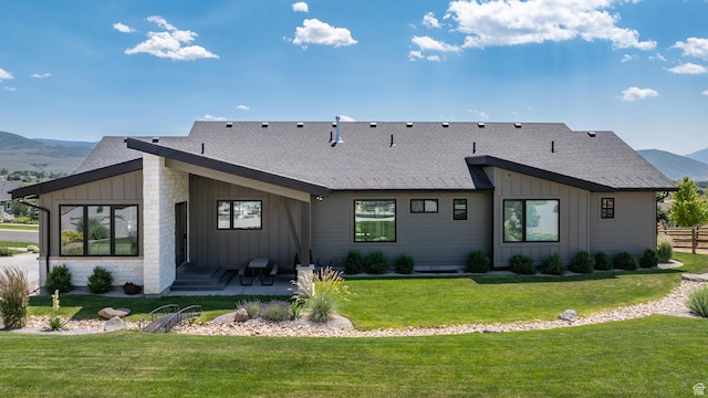 3131 E Lindsay Spring Rd, Heber City, UT 84032 - rear view of house featuring a mountain view, board and batten siding, a patio area, fence, and a lawn