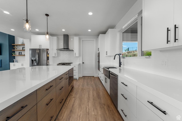 3131 E Lindsay Spring Rd, Heber City, UT 84032 - kitchen with wall chimney exhaust hood, white cabinetry, wood finished floors, light countertops, and stainless steel appliances