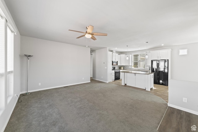 unfurnished living room with ceiling fan, a sink, recessed lighting, baseboards, and light wood-type flooring