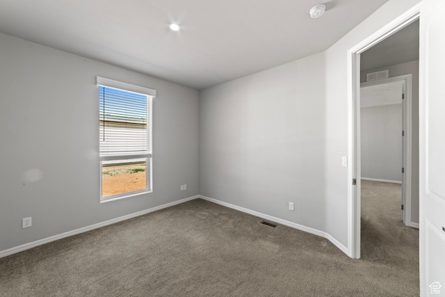 unfurnished bedroom with carpet floors, baseboards, and visible vents