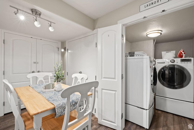 washroom with track lighting, laundry area, dark wood finished floors, and washer and clothes dryer