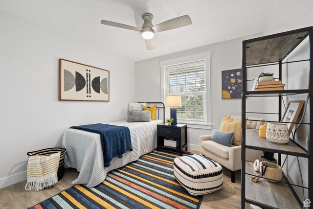 bedroom featuring wood finished floors, ceiling fan, and baseboards