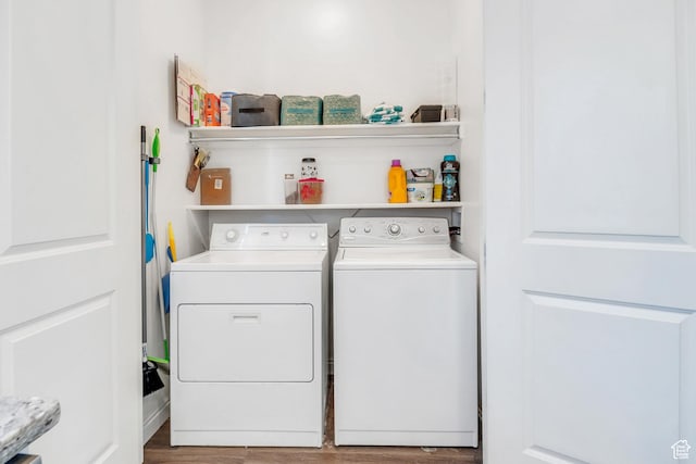 laundry area with washer and dryer, laundry area, and wood finished floors