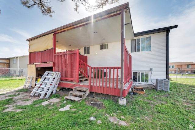 back of house with a yard, a deck, fence, and cooling unit