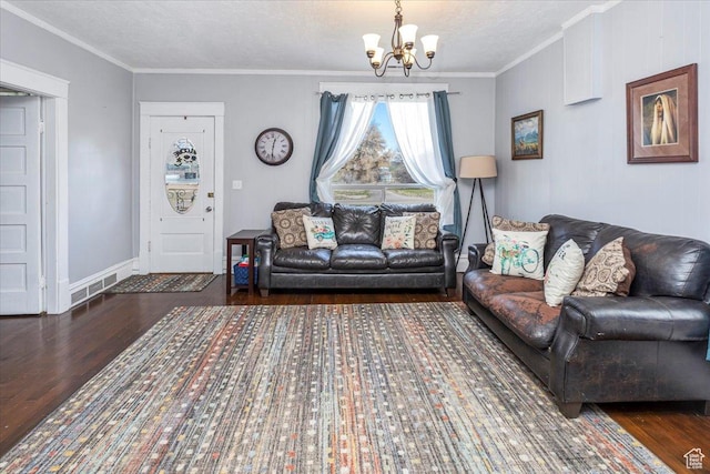 living room with a chandelier, crown molding, and wood finished floors