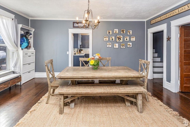 dining room with a notable chandelier, baseboards, ornamental molding, dark wood-style floors, and stairs