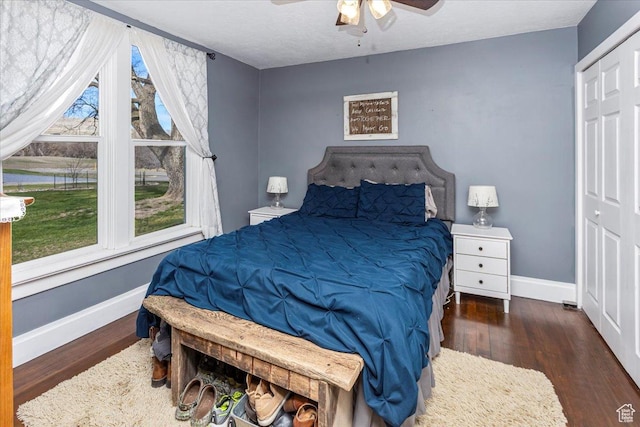 bedroom with wood finished floors, baseboards, and a ceiling fan