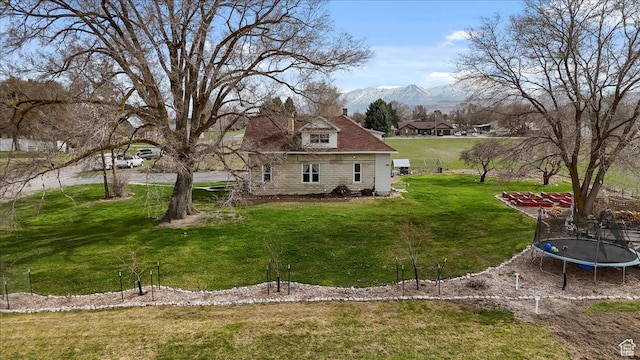 exterior space featuring a trampoline and a mountain view