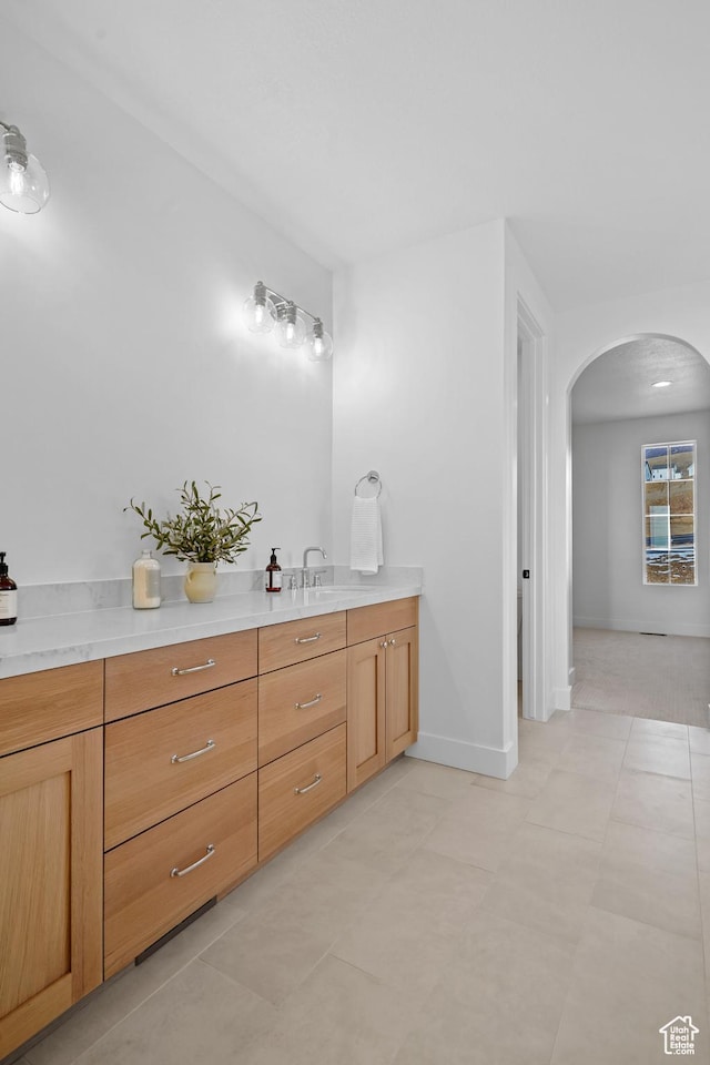 bathroom featuring vanity and baseboards