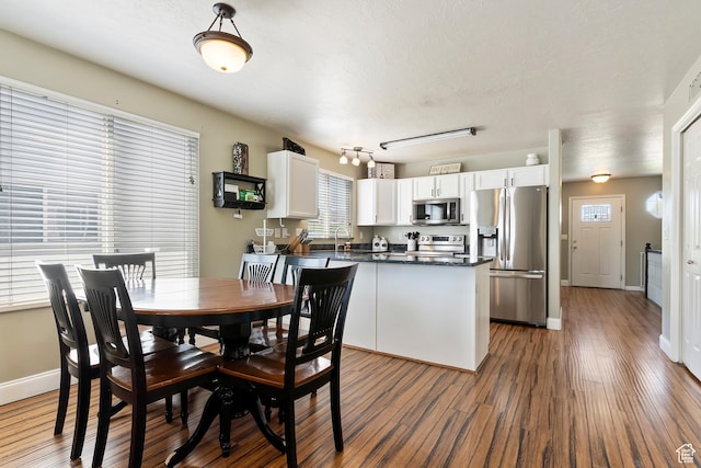 6761 S High Bluff Dr W, West Jordan, UT 84084 - dining room with baseboards and wood finished floors