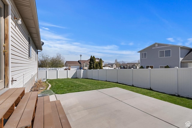 6761 S High Bluff Dr W, West Jordan, UT 84084 - view of yard featuring a patio, a fenced backyard, and a residential view