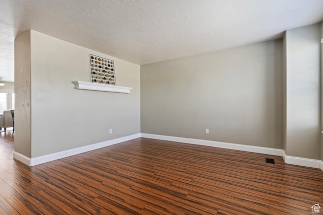 6761 S High Bluff Dr W, West Jordan, UT 84084 - empty room featuring visible vents, baseboards, a textured ceiling, and wood finished floors