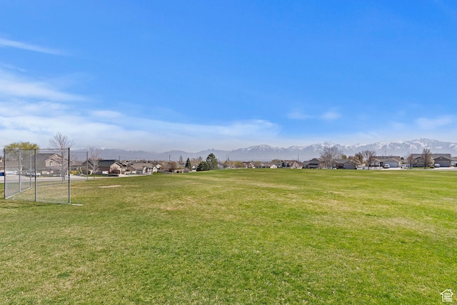6761 S High Bluff Dr W, West Jordan, UT 84084 - view of yard featuring a residential view, a mountain view, and fence