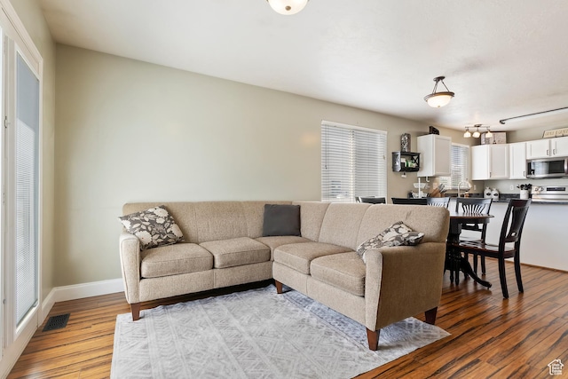 6761 S High Bluff Dr W, West Jordan, UT 84084 - living area featuring visible vents, baseboards, and light wood-type flooring