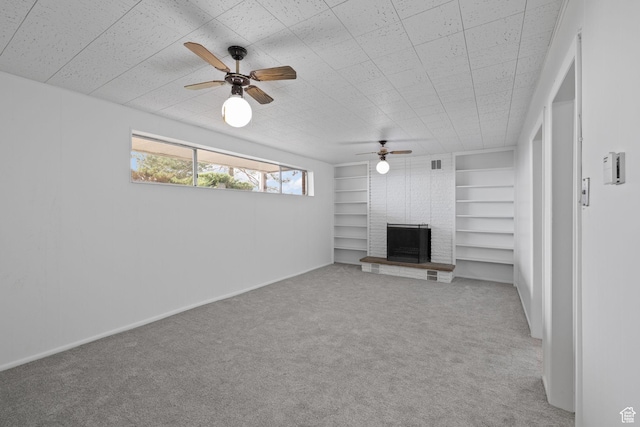 3481 S 3530 E, Salt Lake City, UT 84109 - unfurnished living room featuring built in features, baseboards, a ceiling fan, a fireplace, and carpet flooring