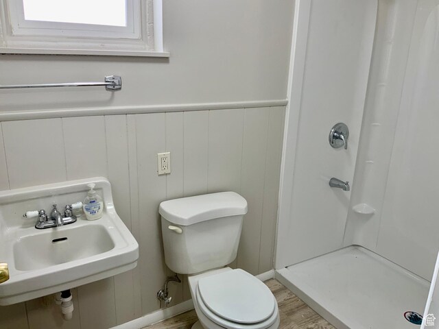 165 W 500 N, Richfield, UT 84701 - bathroom with a shower stall, toilet, wood finished floors, a decorative wall, and a sink