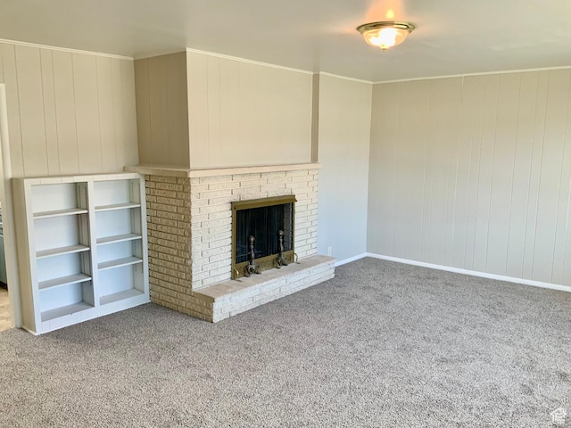165 W 500 N, Richfield, UT 84701 - unfurnished living room featuring carpet floors, a fireplace, wood walls, baseboards, and crown molding