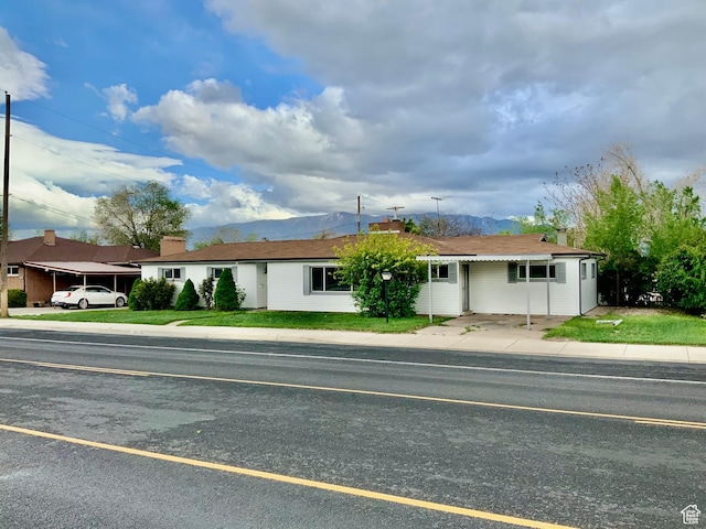 165 W 500 N, Richfield, UT 84701 - ranch-style house with a chimney, a mountain view, and a front lawn