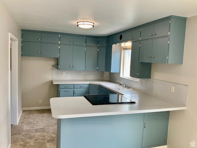 165 W 500 N, Richfield, UT 84701 - kitchen with black electric stovetop, a sink, a peninsula, light countertops, and baseboards