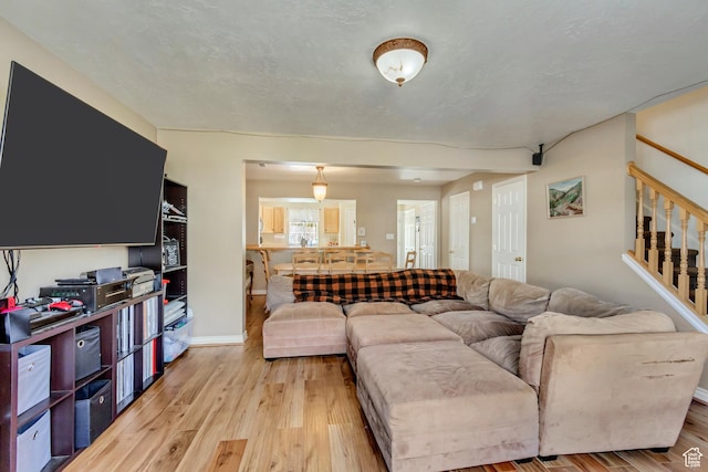 1021 E Riverbend Ln S, Ogden, UT 84404 - living room featuring light wood-type flooring and stairs