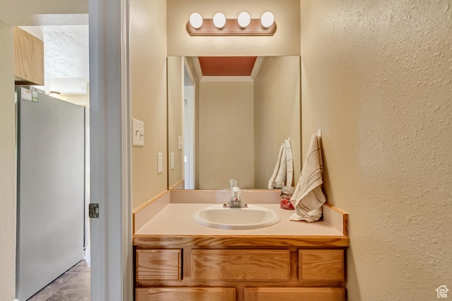 1021 E Riverbend Ln S, Ogden, UT 84404 - bathroom featuring crown molding, a textured wall, and vanity