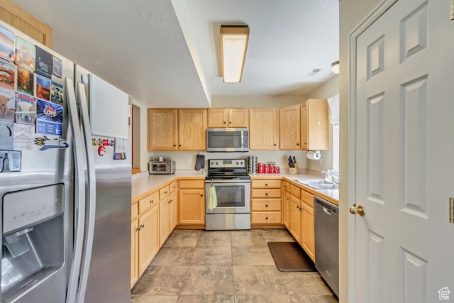 1021 E Riverbend Ln S, Ogden, UT 84404 - kitchen with light countertops, a sink, light brown cabinets, and stainless steel appliances