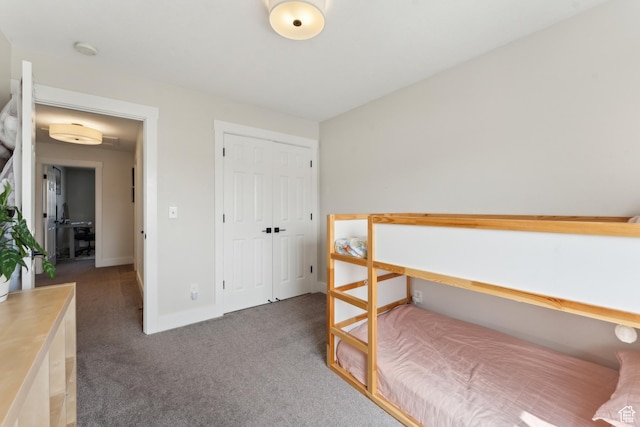 bedroom featuring a closet, baseboards, and carpet floors