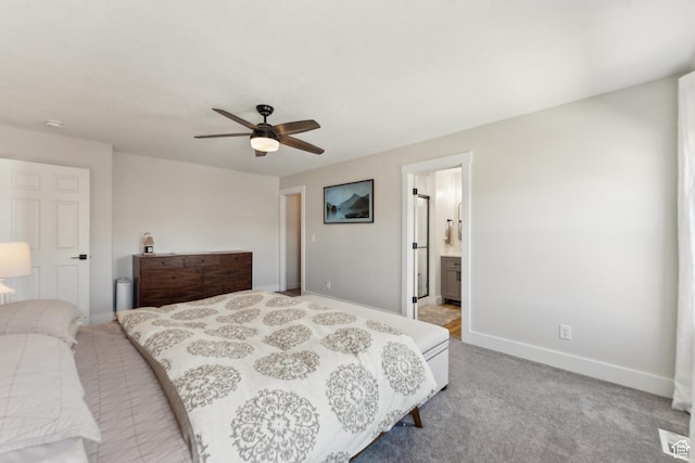 bedroom with ensuite bathroom, baseboards, ceiling fan, and light carpet