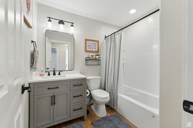 full bathroom with shower / bathtub combination with curtain, vanity, toilet, and wood finished floors