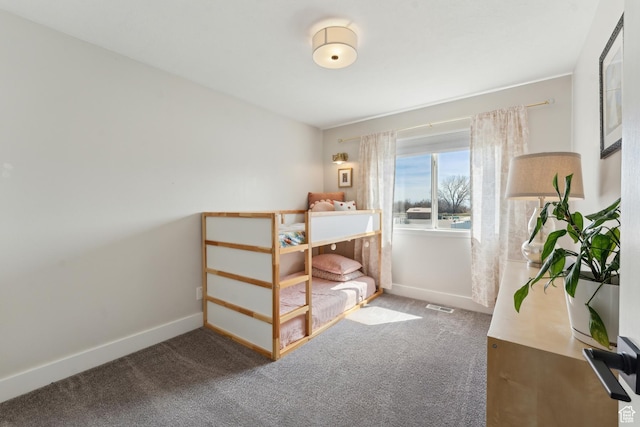 carpeted bedroom featuring visible vents and baseboards