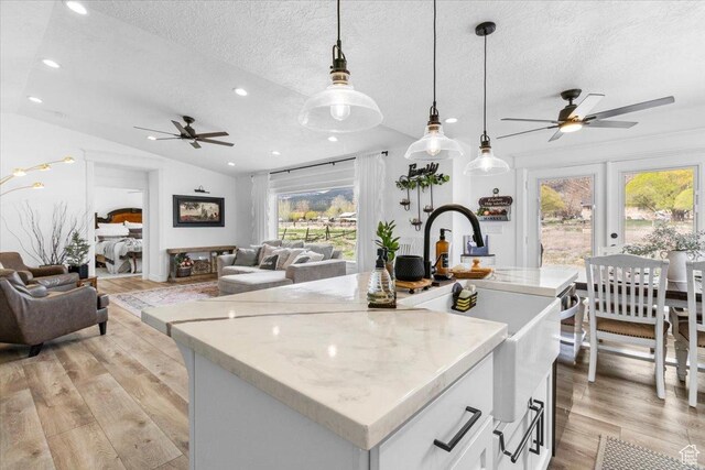 140 S 100 E, Wales, UT 84667 - kitchen featuring light wood-style flooring, open floor plan, ceiling fan, and a textured ceiling