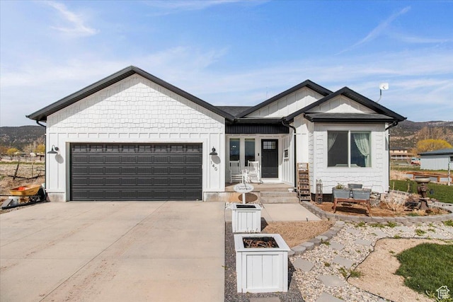ranch-style home featuring a garage, driveway, and board and batten siding