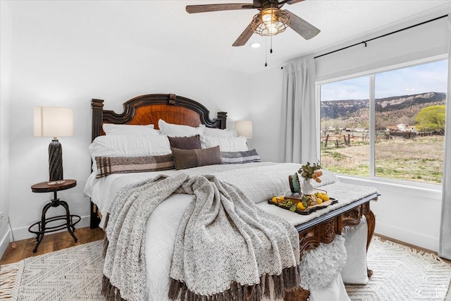 140 S 100 E, Wales, UT 84667 - bedroom with a mountain view, wood finished floors, ceiling fan, and baseboards