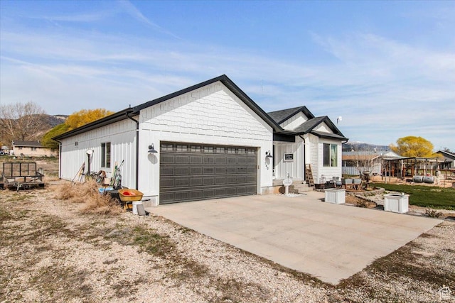 140 S 100 E, Wales, UT 84667 - view of front of property featuring a garage, board and batten siding, and concrete driveway