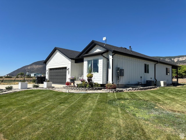 140 S 100 E, Wales, UT 84667 - view of property exterior with a mountain view, board and batten siding, a garage, and a lawn