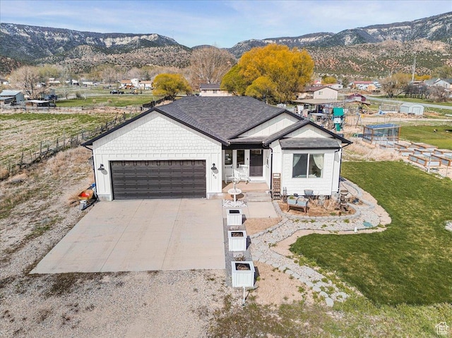 140 S 100 E, Wales, UT 84667 - ranch-style home featuring a mountain view, concrete driveway, a garage, and a front yard