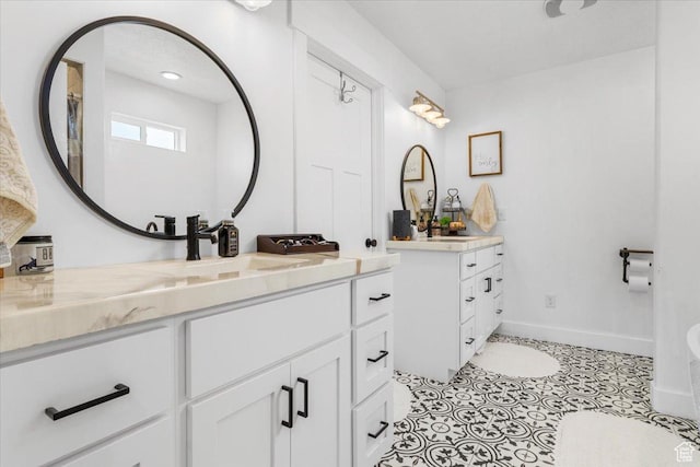 140 S 100 E, Wales, UT 84667 - bathroom featuring tile patterned floors, two vanities, a sink, and baseboards