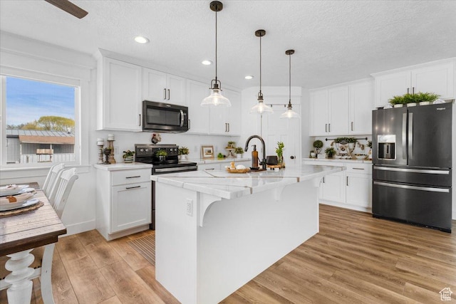 140 S 100 E, Wales, UT 84667 - kitchen featuring stainless steel fridge with ice dispenser, light wood finished floors, white cabinetry, and electric range oven