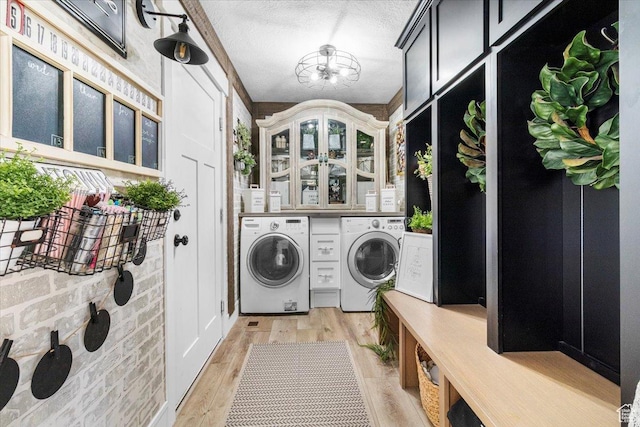 140 S 100 E, Wales, UT 84667 - laundry area with a chandelier, light wood-style flooring, a textured ceiling, cabinet space, and washing machine and clothes dryer