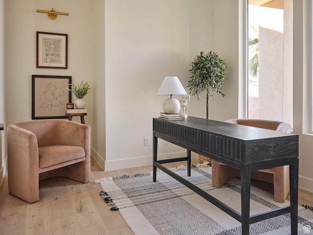 office space with baseboards and wood finished floors