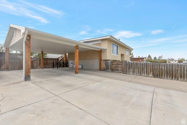 6828 S Georgia Dr, West Jordan, UT 84084 - view of property exterior with a carport, driveway, and fence
