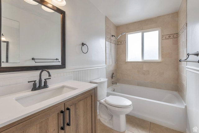 6828 S Georgia Dr, West Jordan, UT 84084 - bathroom featuring bathtub / shower combination, vanity, toilet, wainscoting, and tile patterned floors