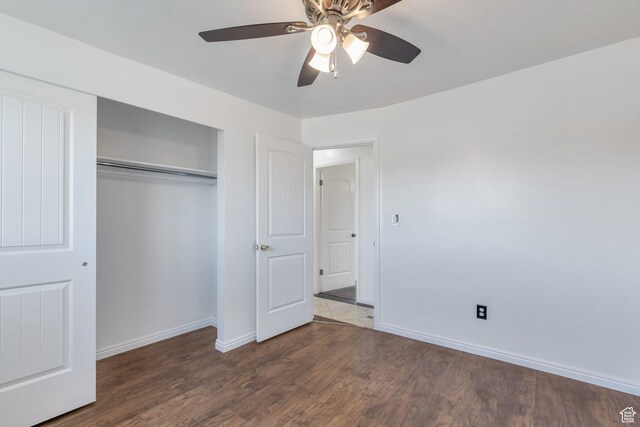 6828 S Georgia Dr, West Jordan, UT 84084 - unfurnished bedroom with a closet, baseboards, a ceiling fan, and wood finished floors