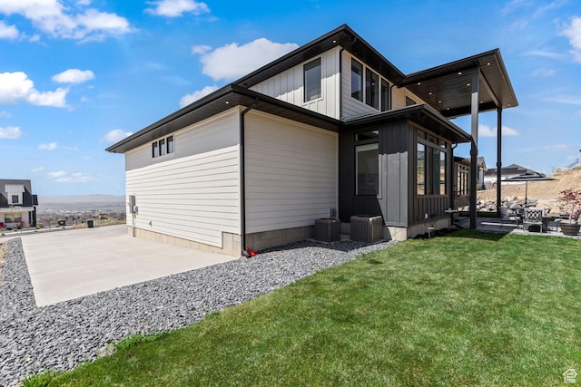 94 S 950 E, Hyde Park, UT 84318 - back of property featuring board and batten siding, central AC, a yard, and a patio