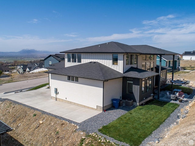 94 S 950 E, Hyde Park, UT 84318 - back of property featuring board and batten siding, a shingled roof, central AC, and a patio area