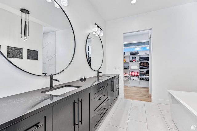 94 S 950 E, Hyde Park, UT 84318 - full bath featuring a freestanding bath, a walk in closet, double vanity, and a sink