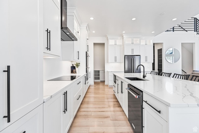 94 S 950 E, Hyde Park, UT 84318 - kitchen featuring a large island, a sink, wall chimney range hood, appliances with stainless steel finishes, and light wood-style flooring