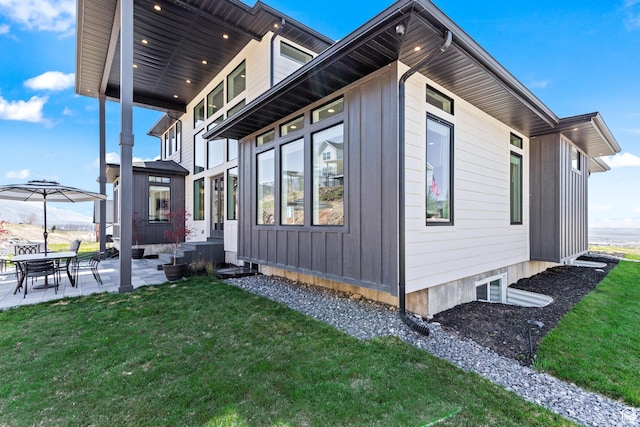 94 S 950 E, Hyde Park, UT 84318 - view of property exterior featuring board and batten siding, a yard, and a patio area