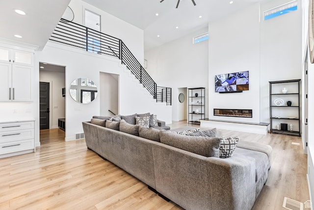 94 S 950 E, Hyde Park, UT 84318 - living area with visible vents, light wood finished floors, a high ceiling, and stairway