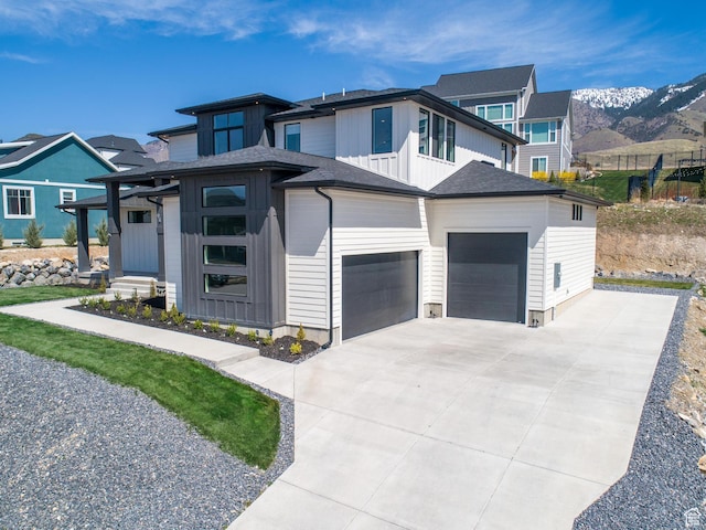 94 S 950 E, Hyde Park, UT 84318 - prairie-style house with board and batten siding, an attached garage, and concrete driveway